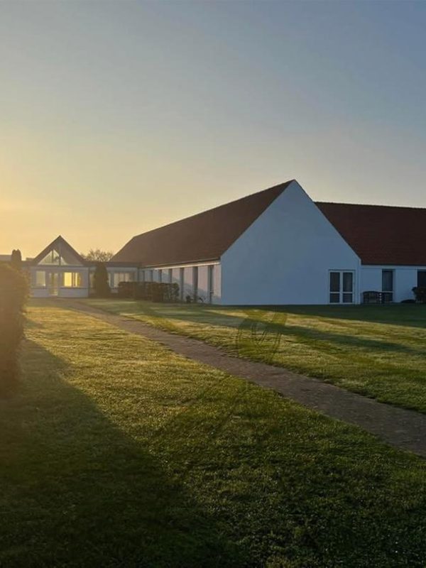 Senior Care Home at Sunset Senior care home building surrounded by green lawn at sunset